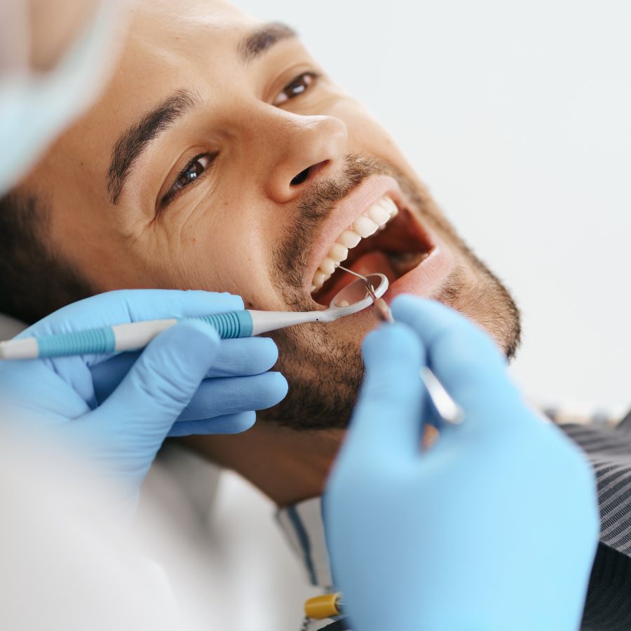 extraction and socket preservation specialist performing an exam